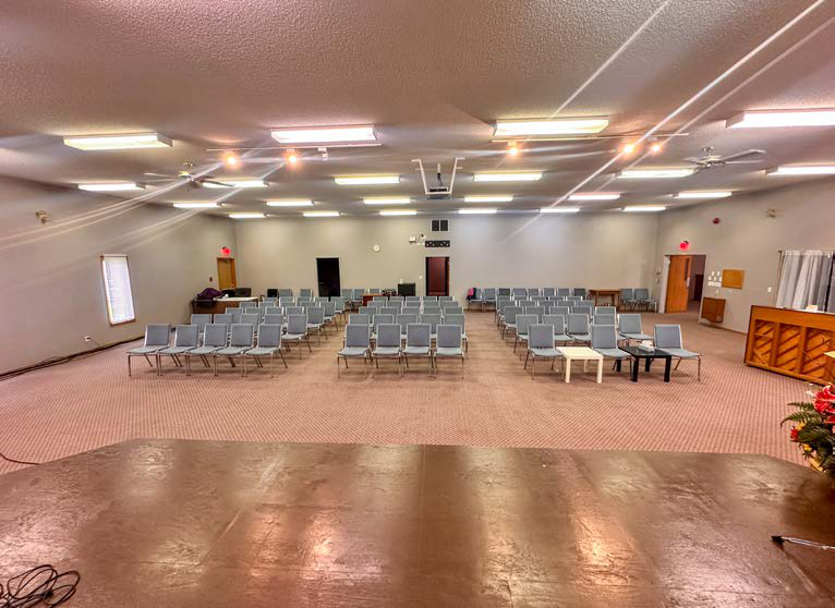 Large gathering room with rows of seating inside the property at 3125 Catalina Boulevard N.E.