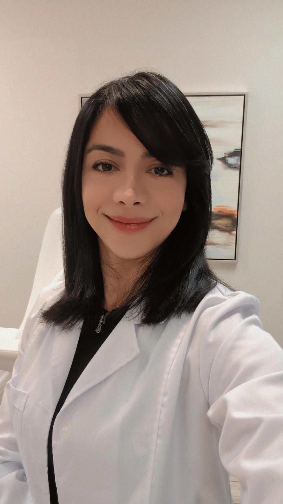 Nurse Moti, Registered Nurse and Cosmetic Injector in white lab coat