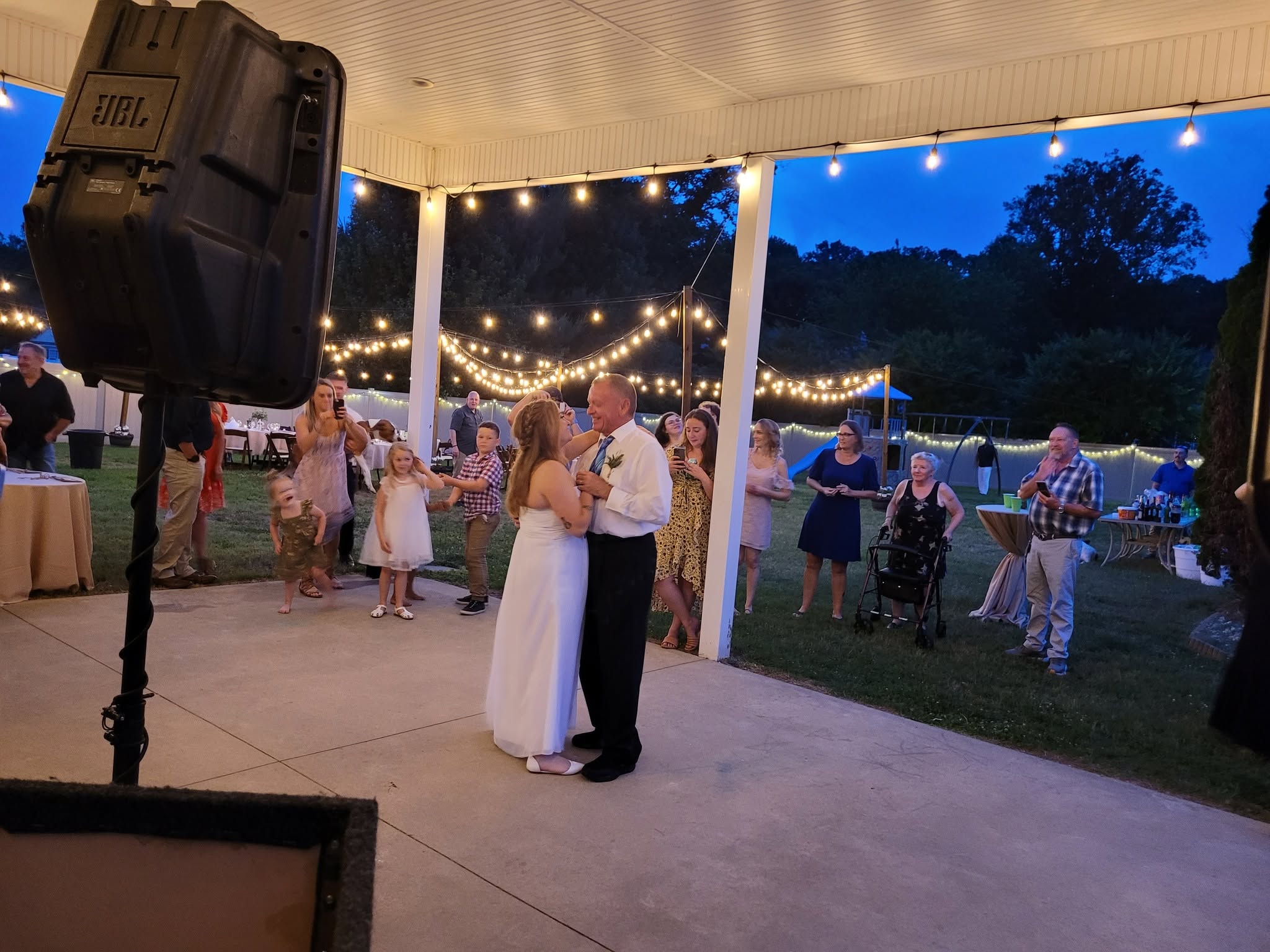 First dance at an outdoor wedding reception with string lights in Delaware