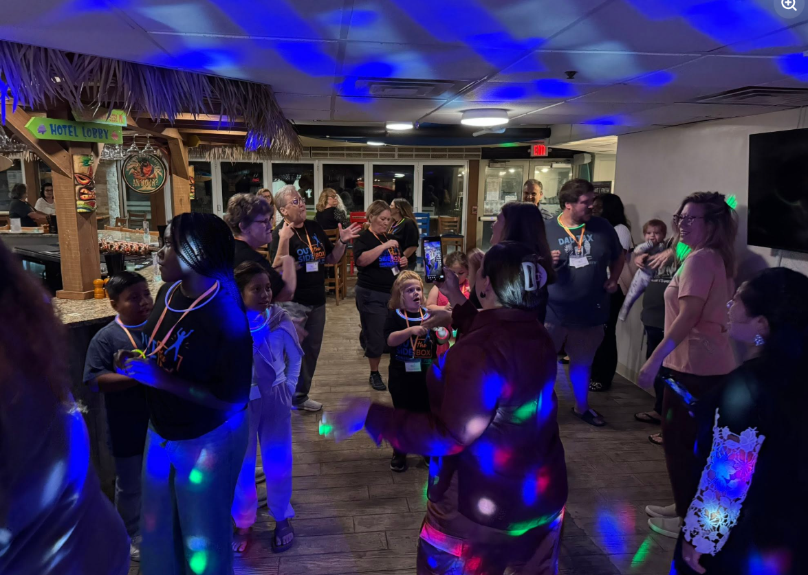 Group dancing together at a tropical-themed event venue in Delaware