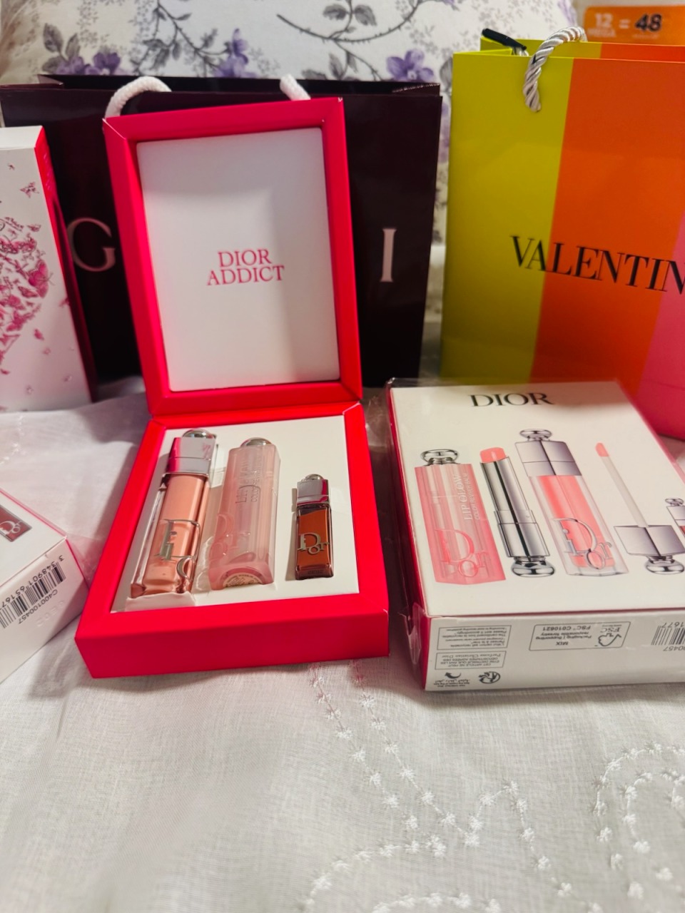 Dior Addict luxury lip glow and beauty gift set collection with pink presentation box and Valentino shopping bag