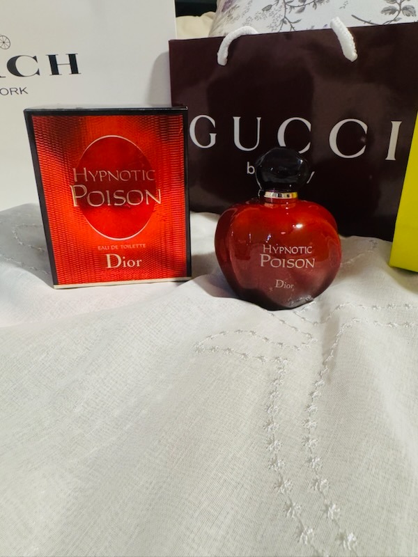 Dior Hypnotic Poison Eau De Toilette red bottle with original presentation box and Gucci shopping bag background