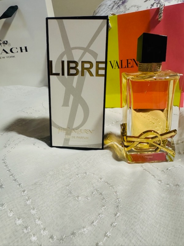 YSL Yves Saint Laurent Libre Eau De Parfum spray bottle with original presentation box and luxury designer background