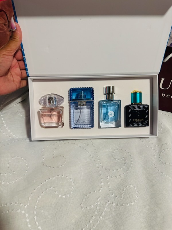Versace perfume gift set featuring four luxury miniature fragrance bottles in white presentation box