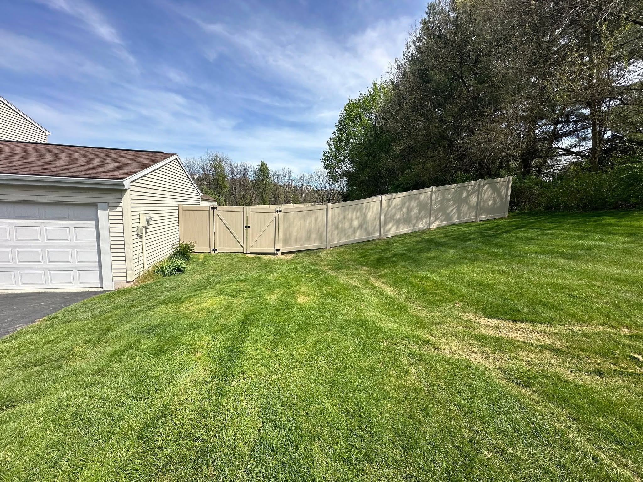 Professional vinyl fence installation with custom gate