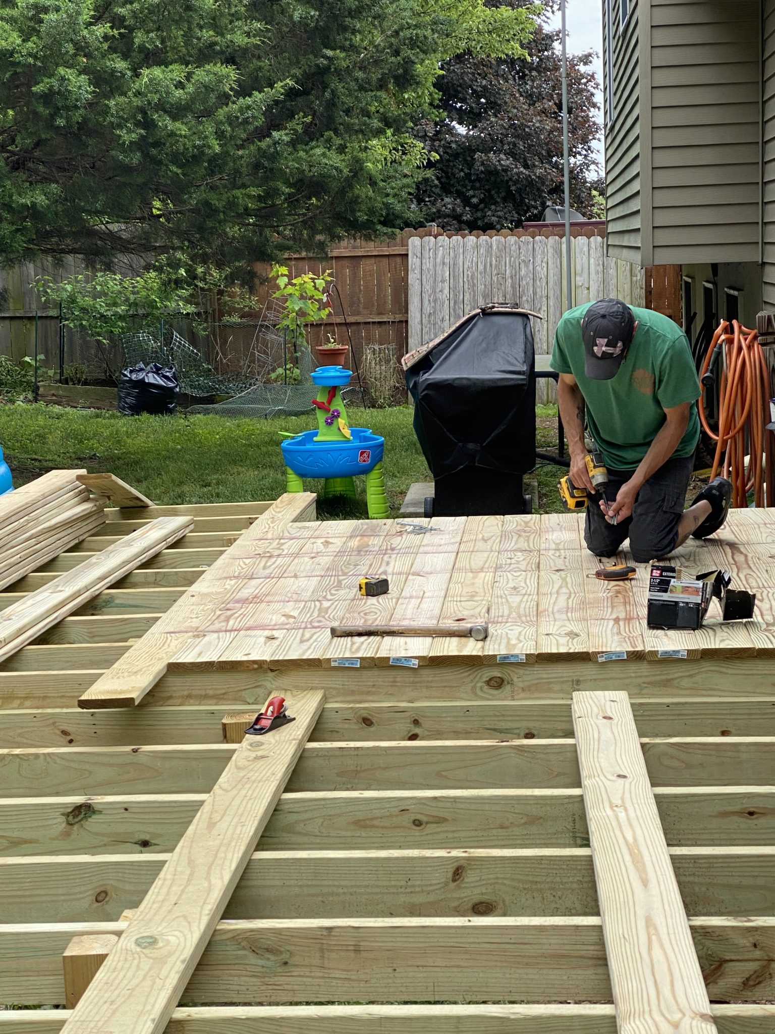 Professional handyman building a deck with power tools and skilled craftsmanship