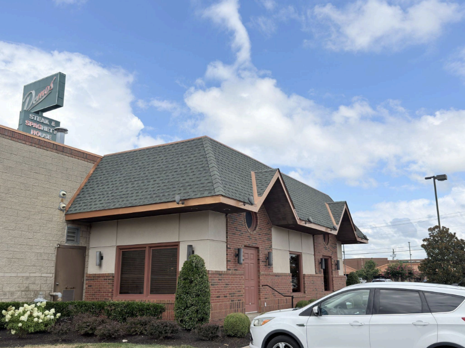Commercial restaurant building undergoing roof replacement by Knock on Wood Roofing & Construction