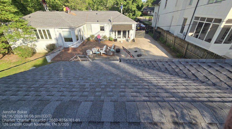 Aerial view of completed dark gray architectural shingle roof on residential property