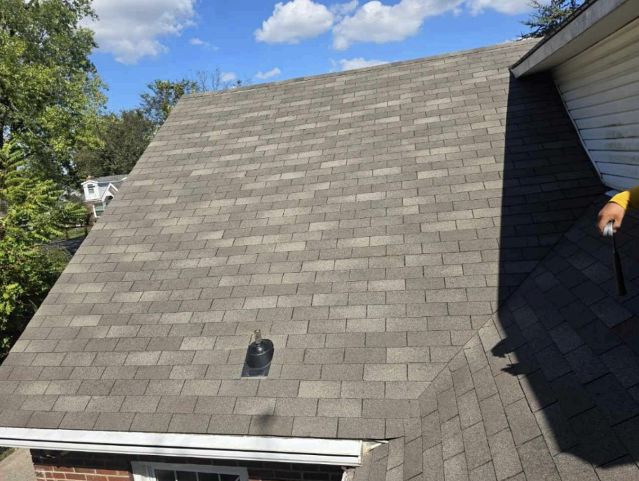 Close-up detail of dark gray architectural shingles showing texture and pattern