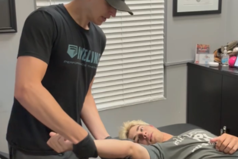 Dr. Caleb Kutsche guiding a patient through 1-on-1 post-surgery arm and shoulder rehabilitation at Incline Performance Therapy