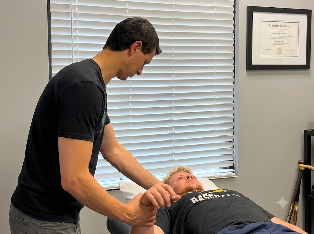 Dr. Caleb Kutsche providing hands-on one-on-one physical therapy treatment to a patient at Incline Performance Therapy in Woodstock GA