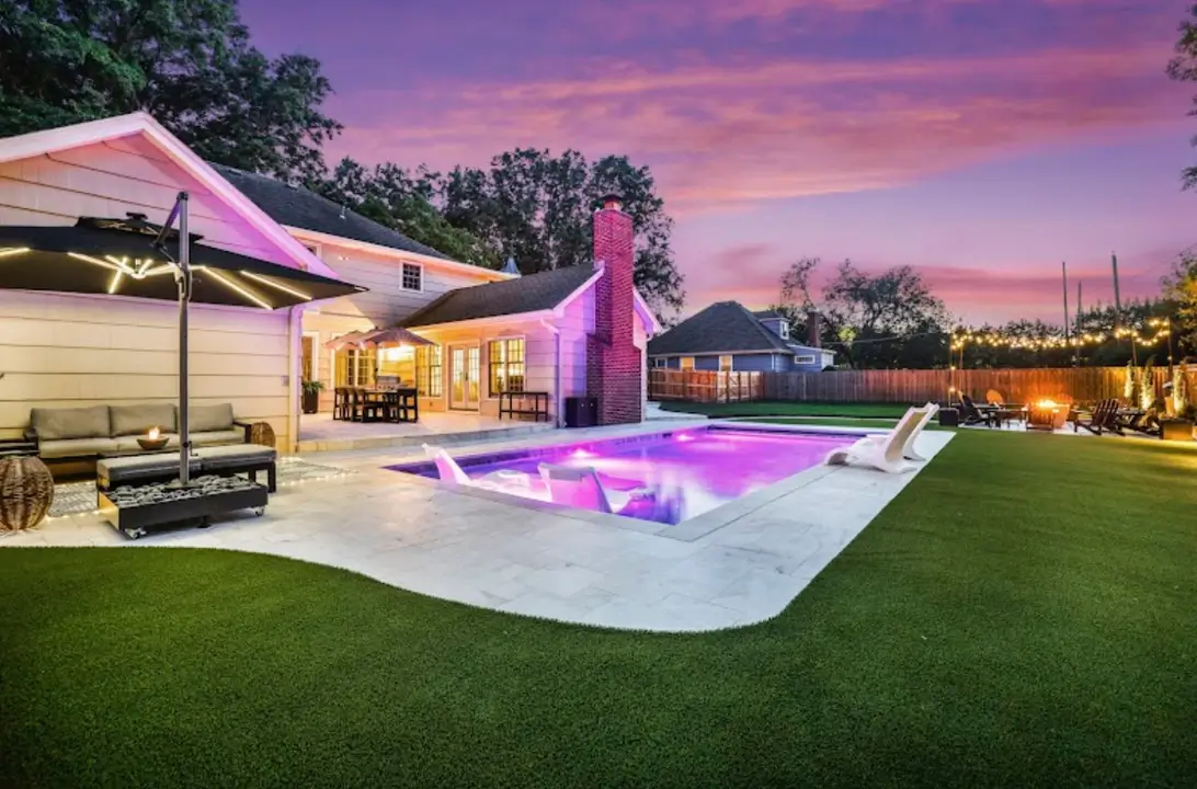 Poolside artificial turf installation with clean edges around a swimming pool in Kansas City