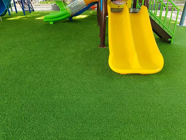 Playground artificial turf installation beneath play equipment in Kansas City