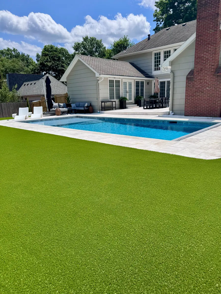 Poolside artificial turf framing the edge of a pool deck in Kansas City