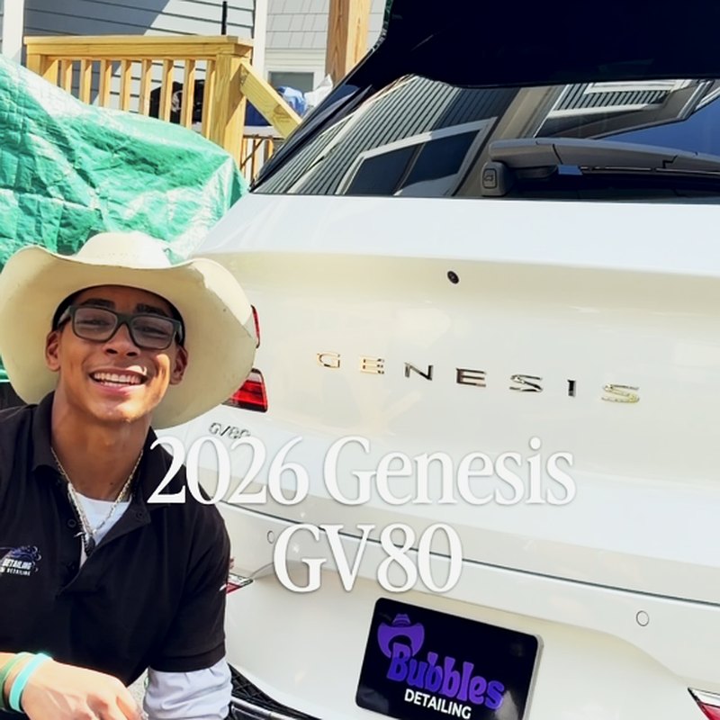 Isaiah smiling with white Genesis GV80 after Bubbles Mobile Detailing service in West Bridgewater MA