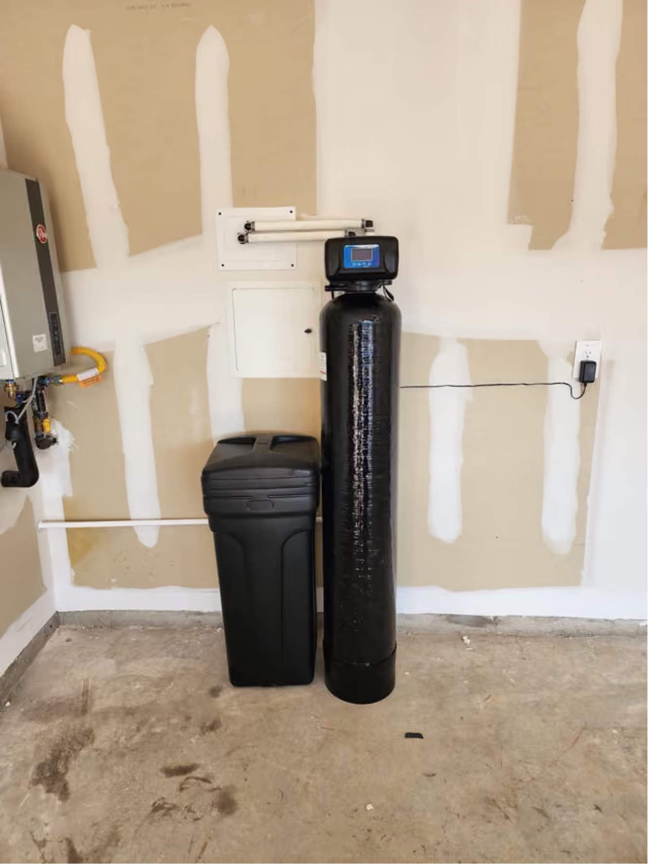 Brookwell whole home water softener and brine tank installed in residential garage