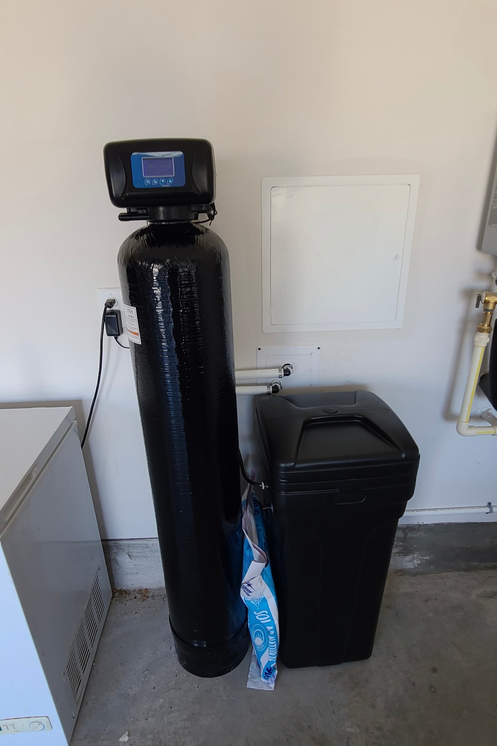 Brookwell whole home water softener and brine tank installed in clean utility space