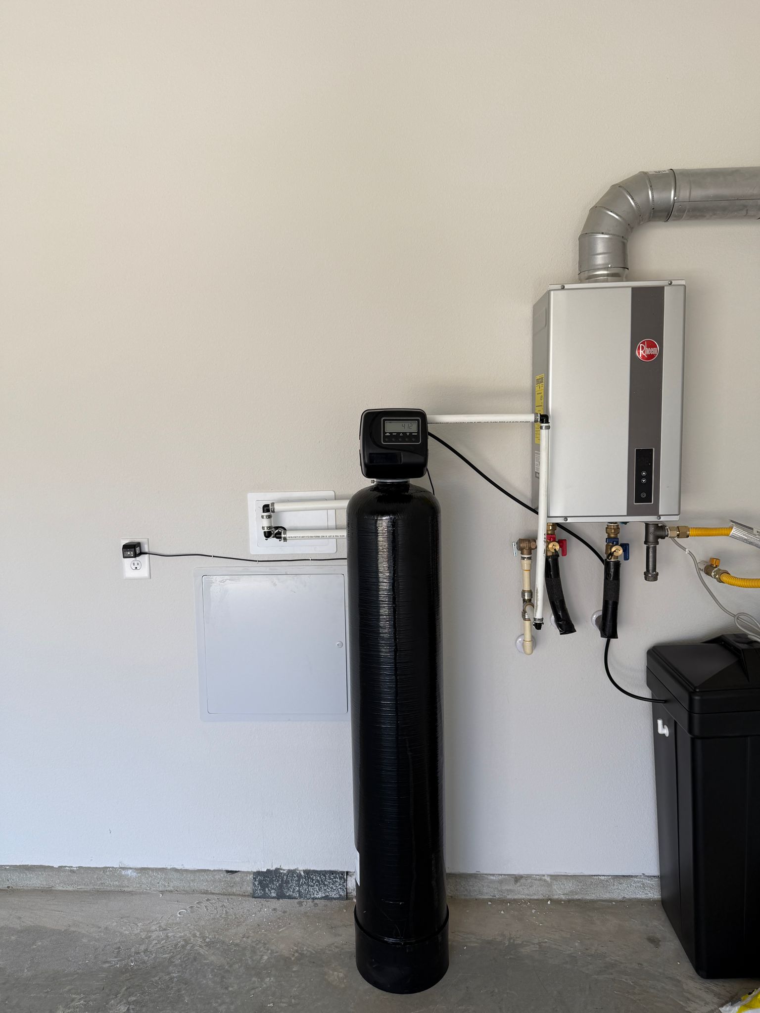 Brookwell water softener installation alongside high-efficiency tankless water heater