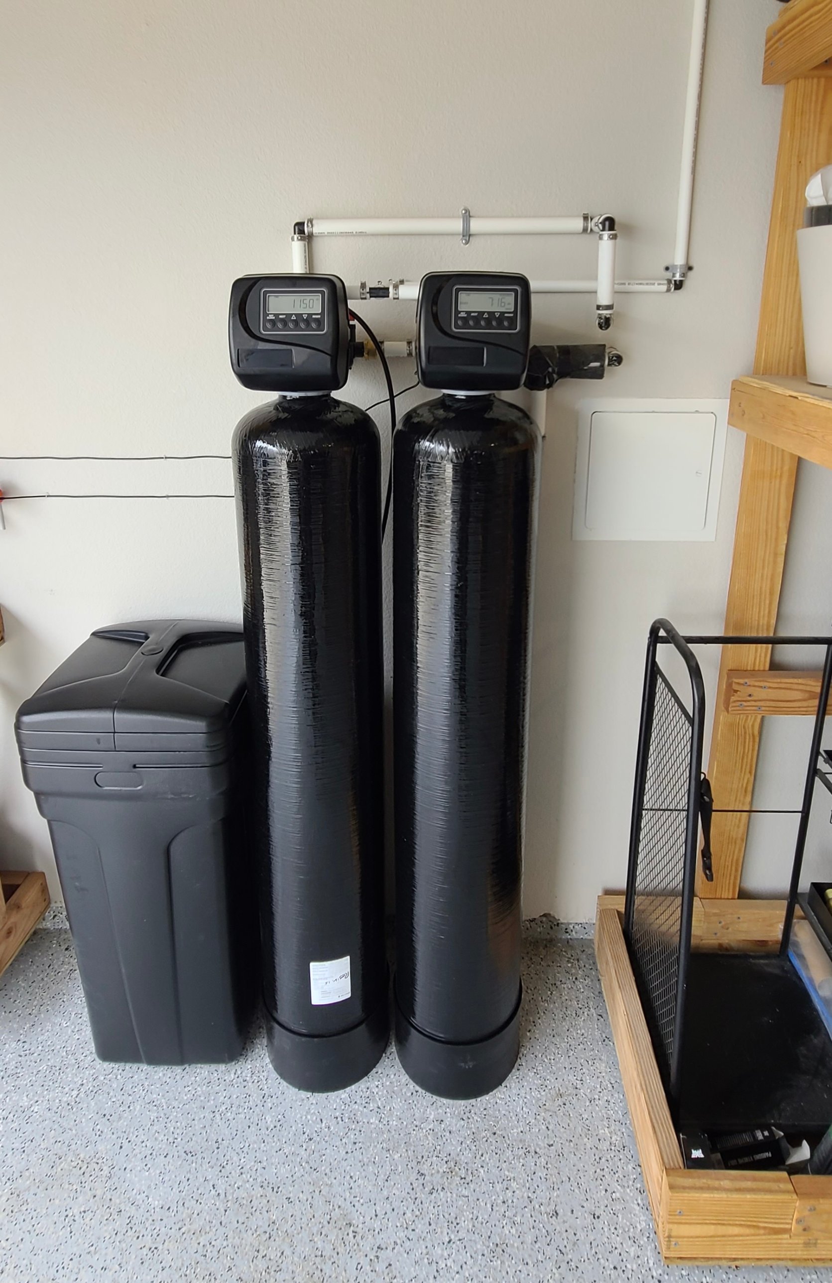 Brookwell dual-tank whole-home water treatment system and brine tank installed in clean residential garage