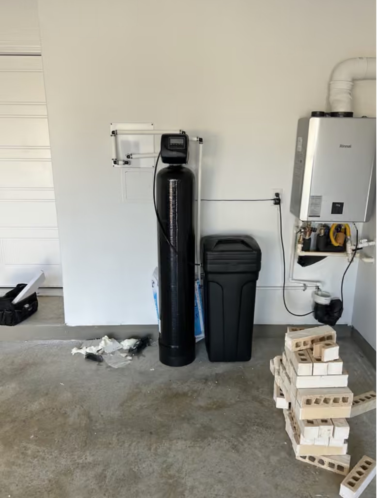 Brookwell water softener installation alongside on-demand water heater in Ontario home
