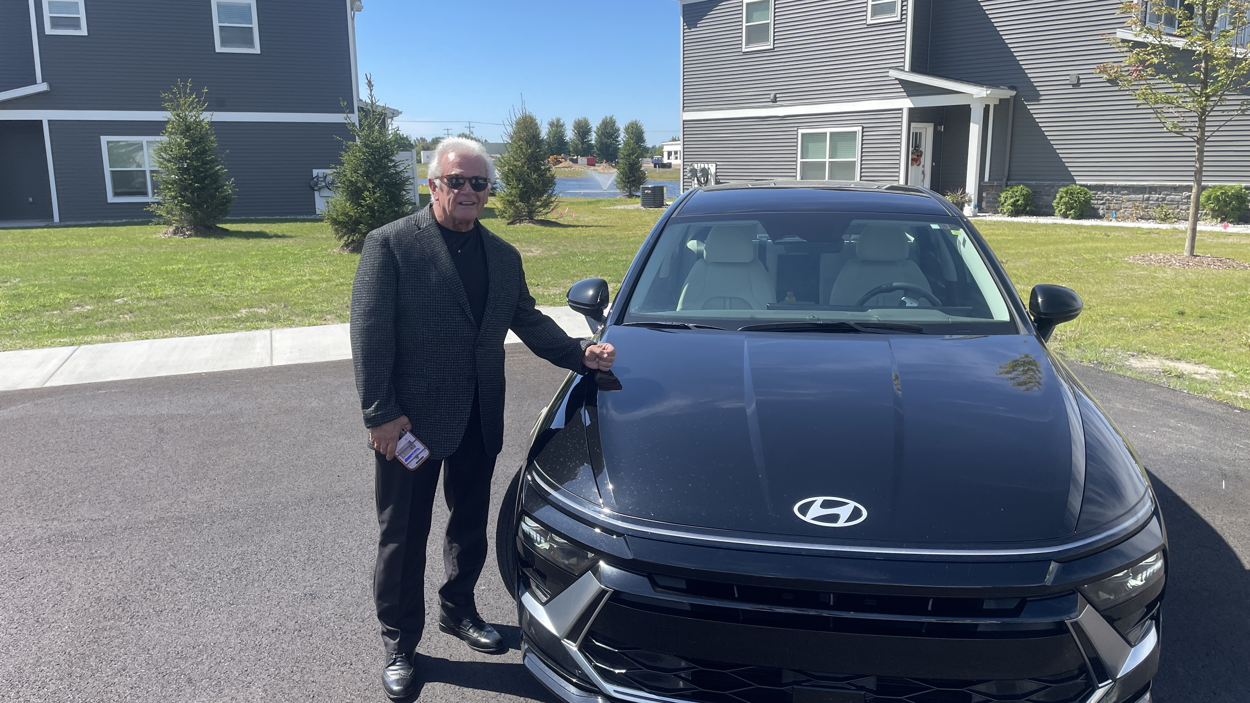 Michael Hanners standing in front of his black executive sedan