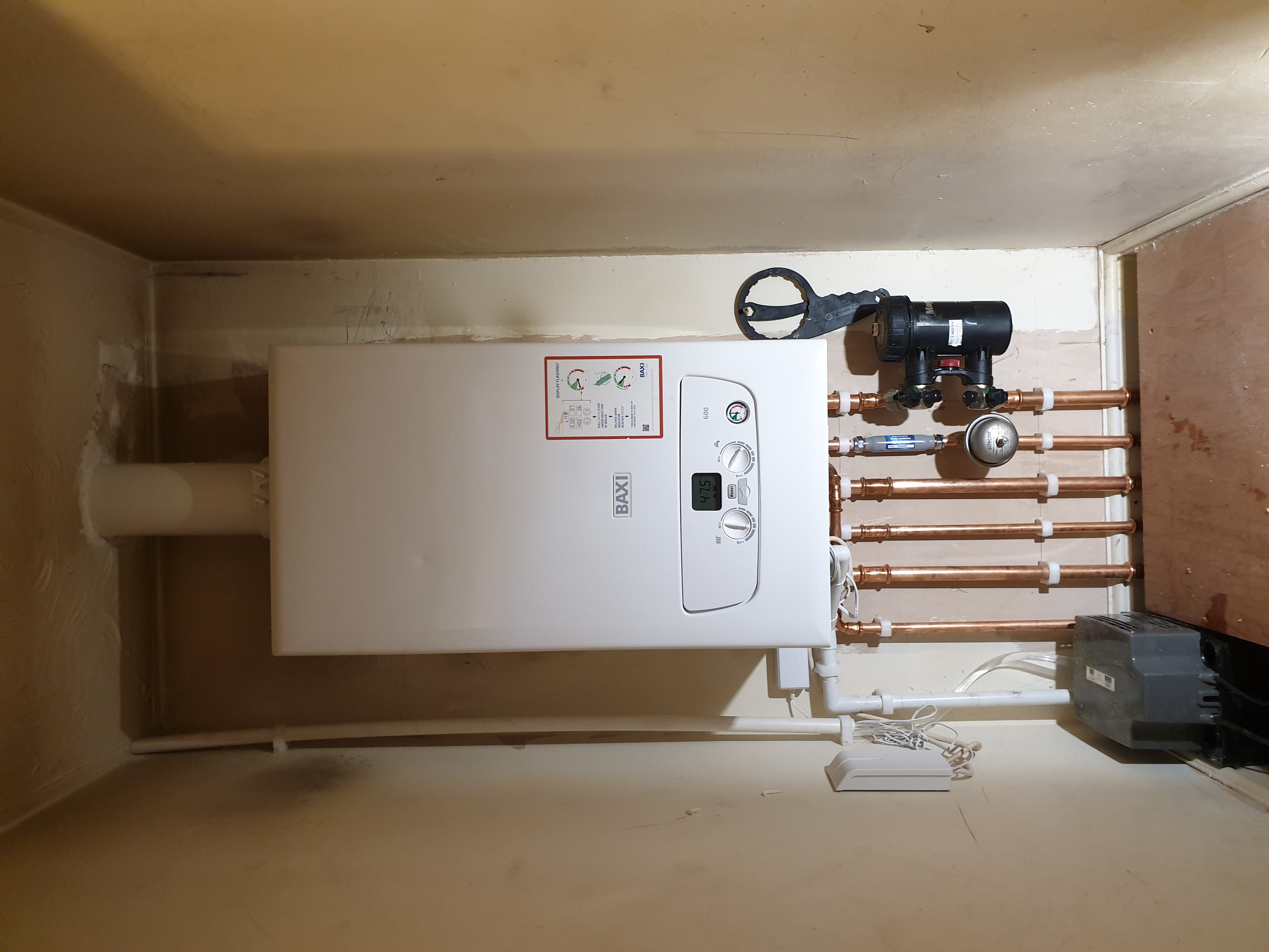 Powerflush machine with Adey magnetic filter showing heavily discoloured brown sludge-laden rods removed from a heating system.