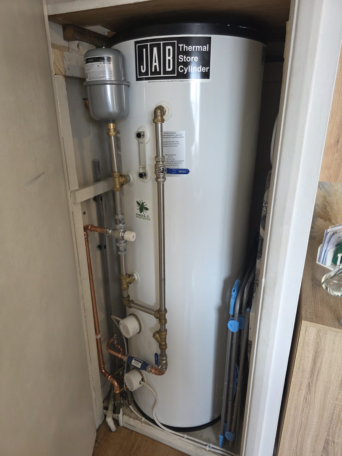 JAB Thermal Store Cylinder installed in a cupboard with exposed pipework.
