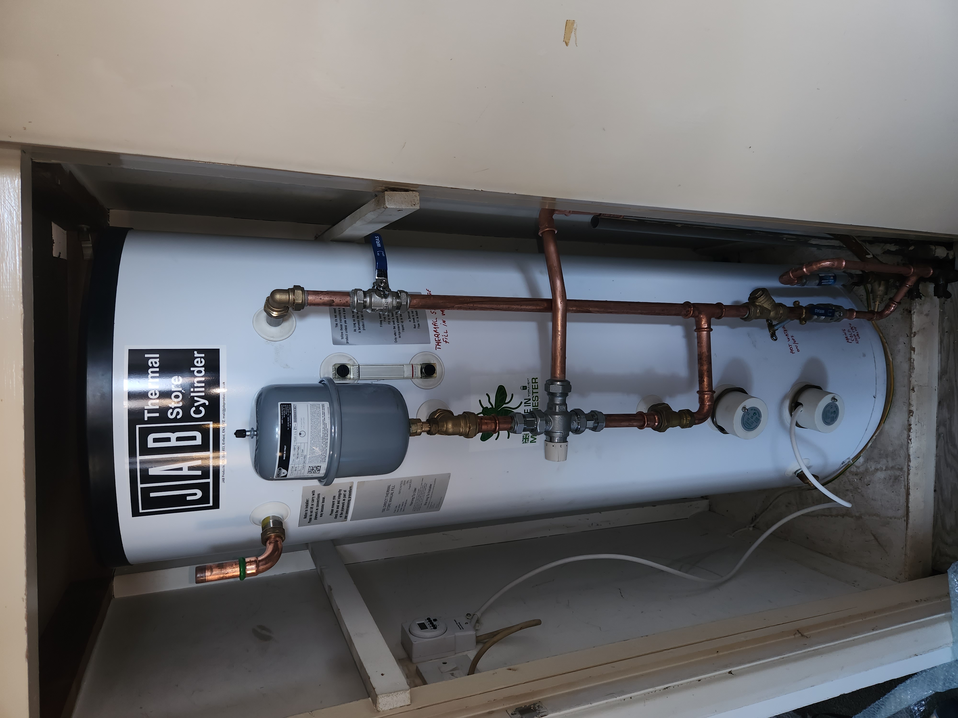 JAB Thermal Store Cylinder installed in a cupboard with expansion vessel, copper pipework and system controls.