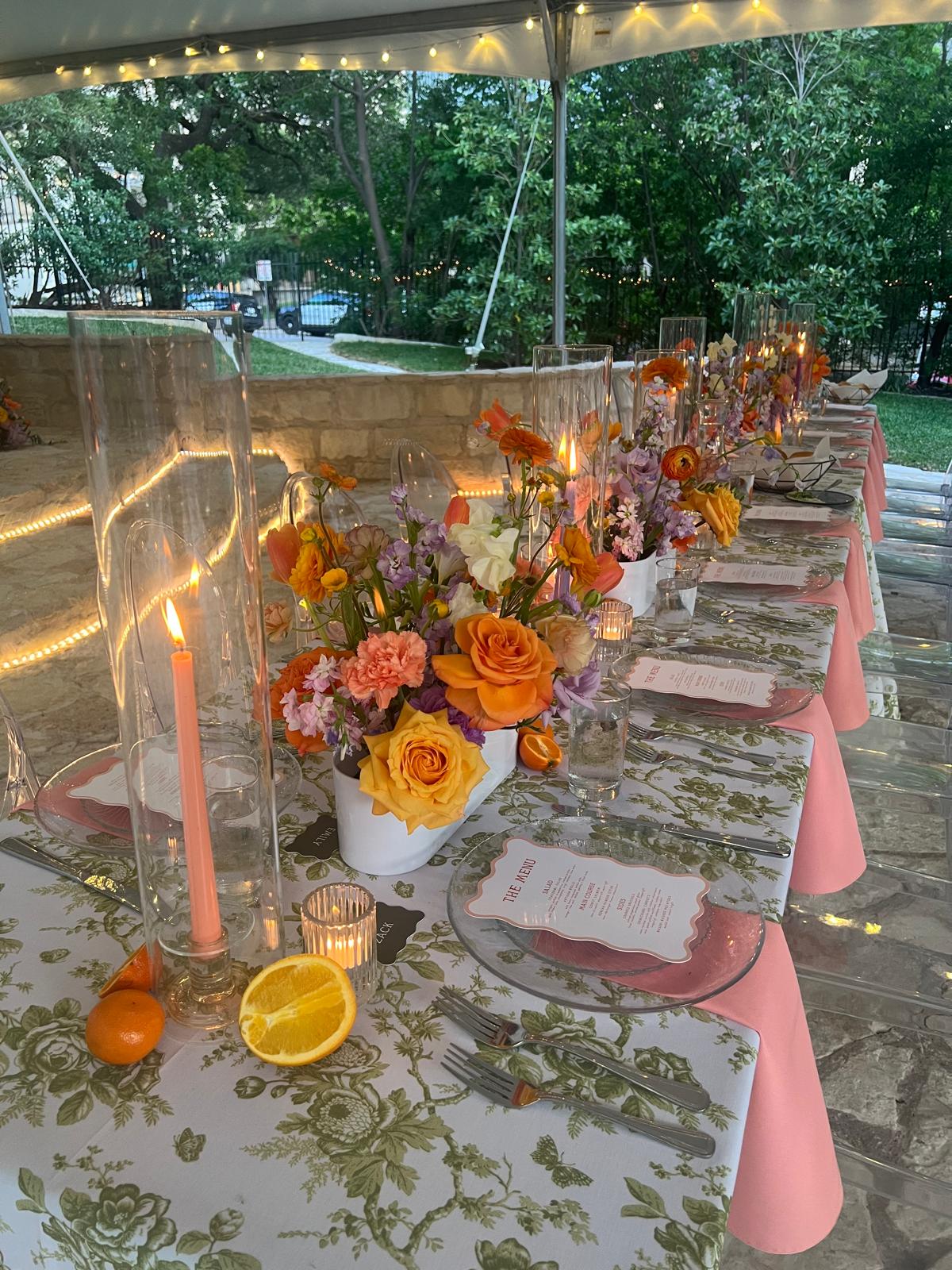 Beautifully set event table with floral centerpieces, candles, and place settings