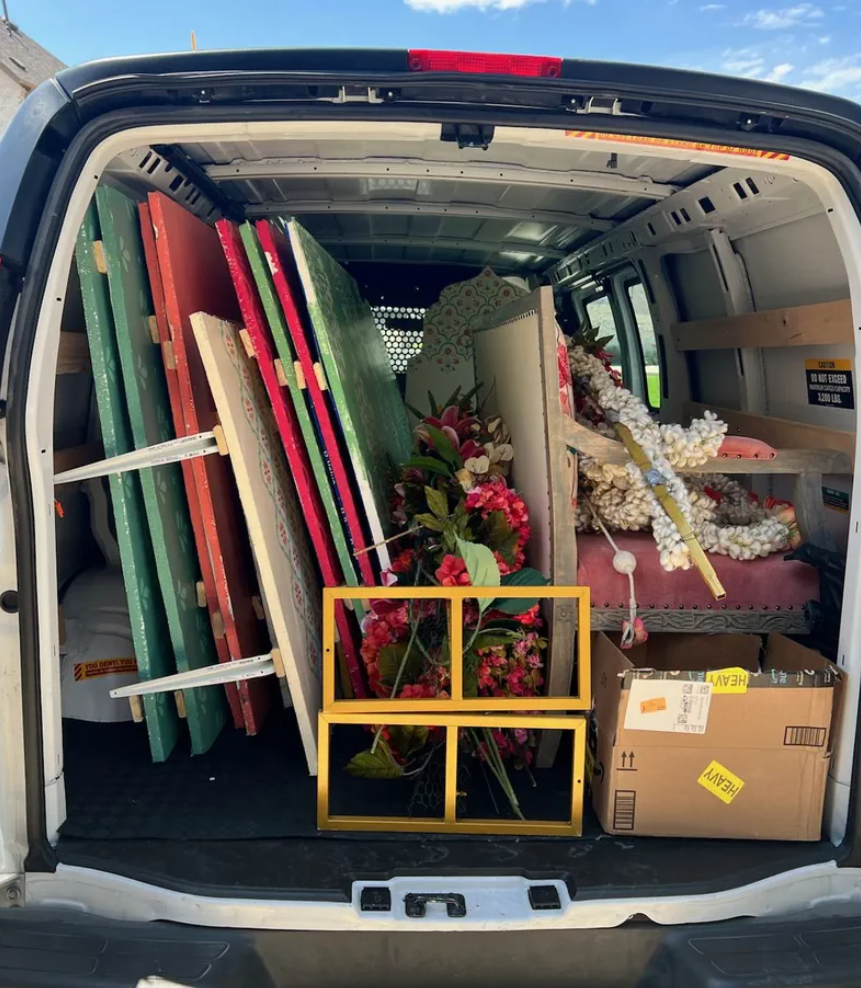 Van fully loaded with floral decor panels, flowers, frames, and event supplies ready for delivery