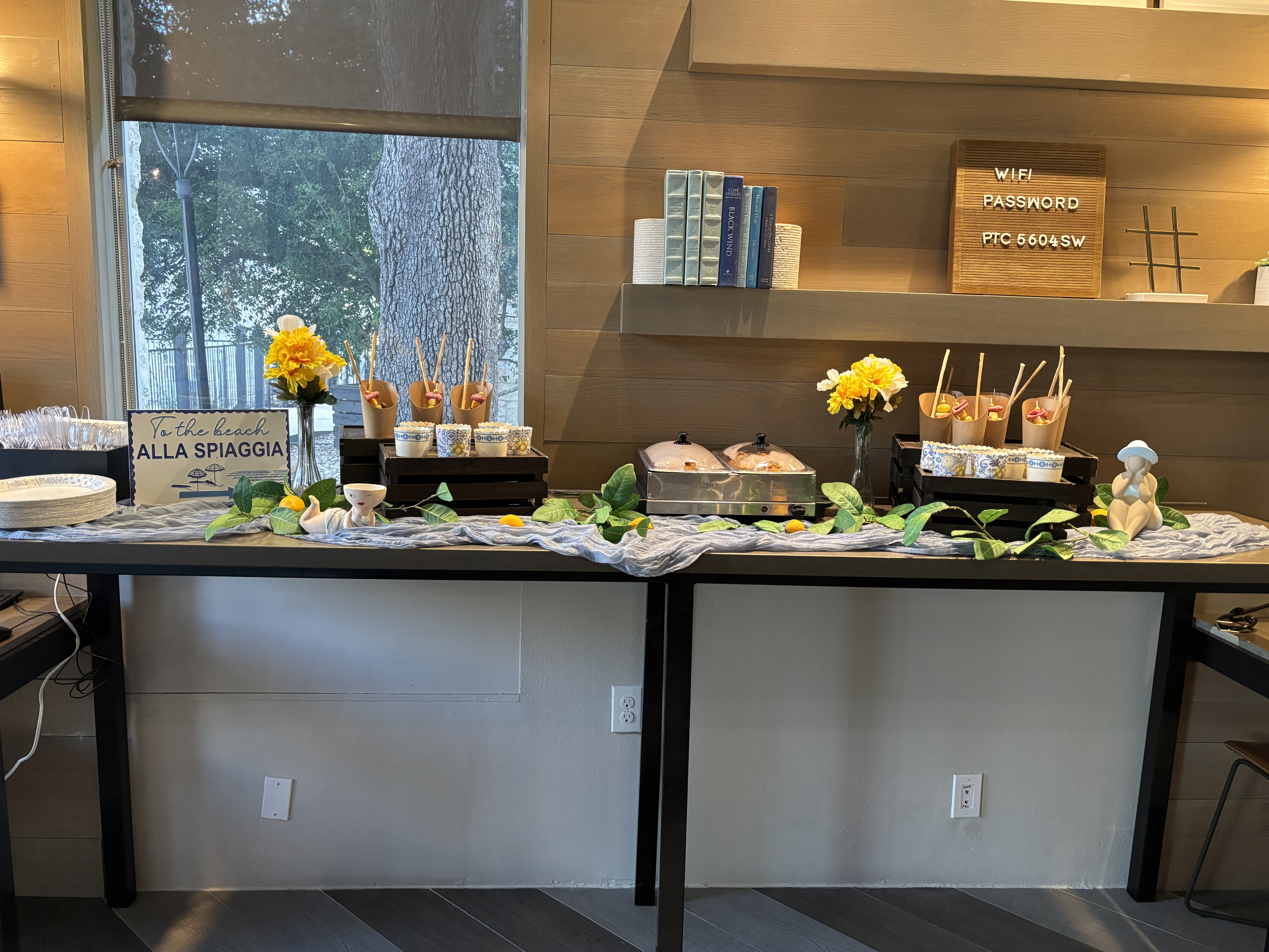 Beautiful welcome table setup with snacks, drinks, flowers, and WiFi sign for vacation rental guests