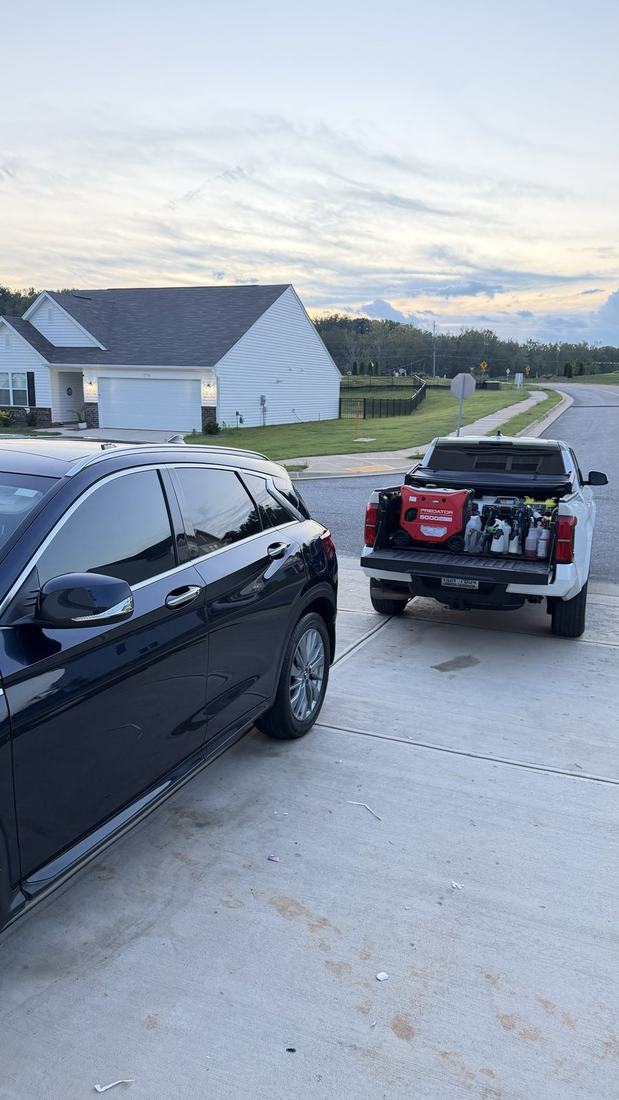 Infiniti SUV and a pickup truck both detailed on site at the same home