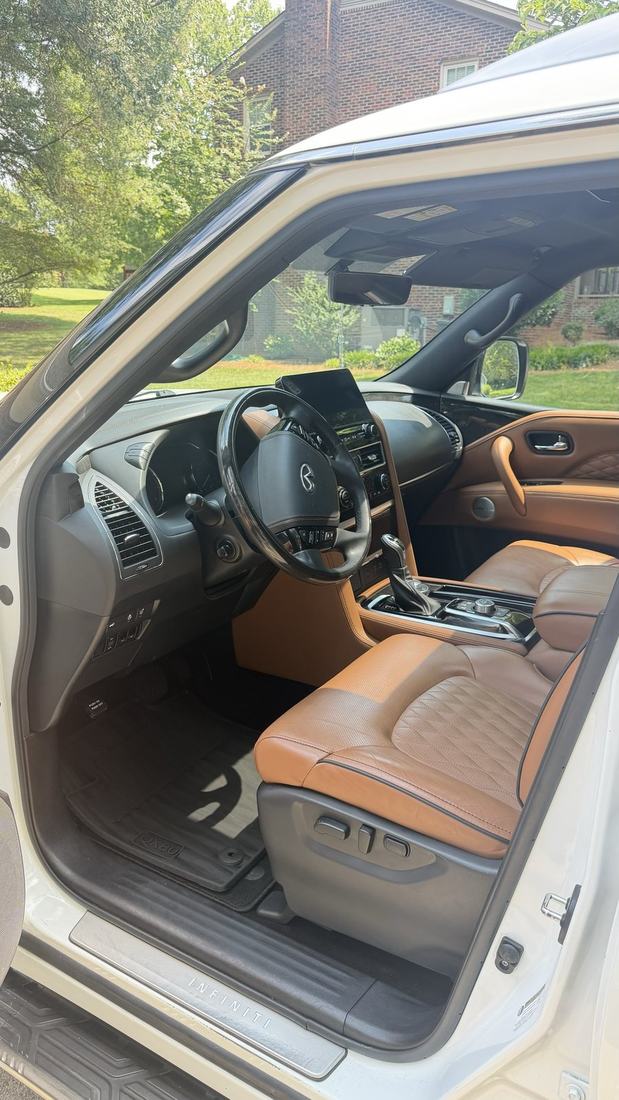 Infiniti QX80 interior detailed with conditioned tan leather seats by Armenta's mobile auto detailing
