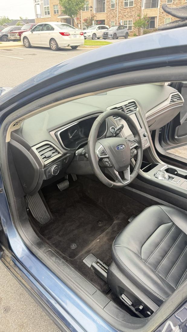 Ford Fusion interior after a full interior detail with cleaned leather seats and carpets