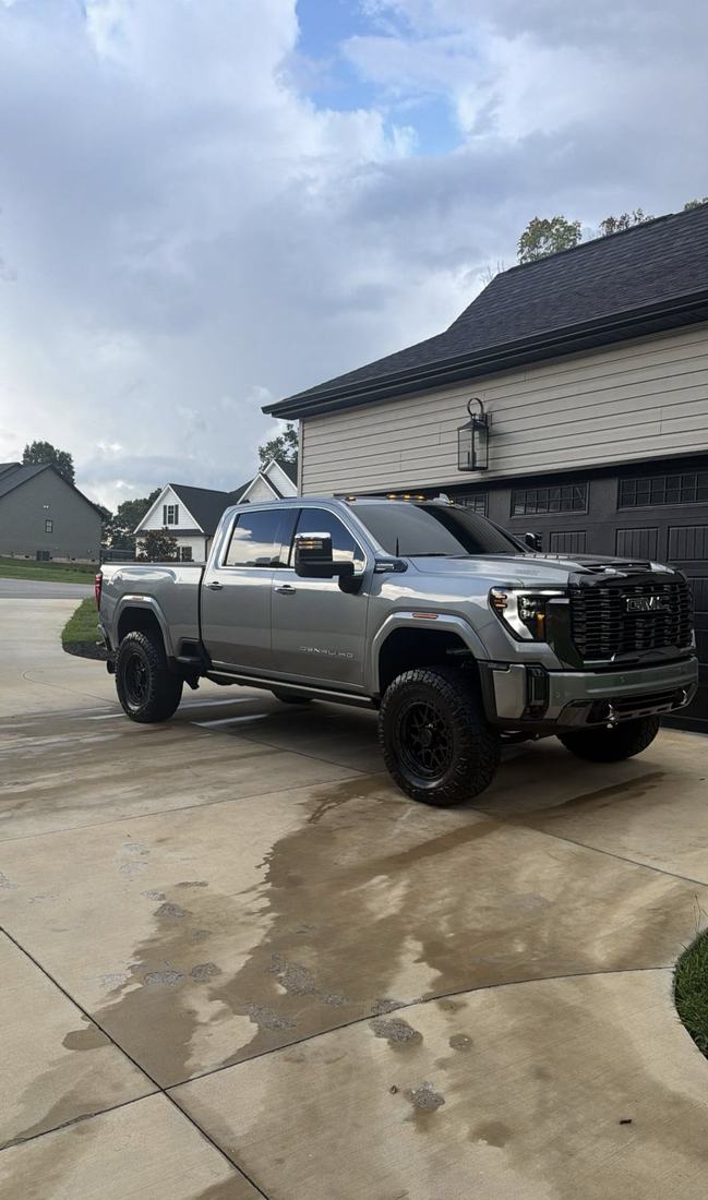 Grey GMC Sierra heavy duty pickup after an exterior detail in a driveway