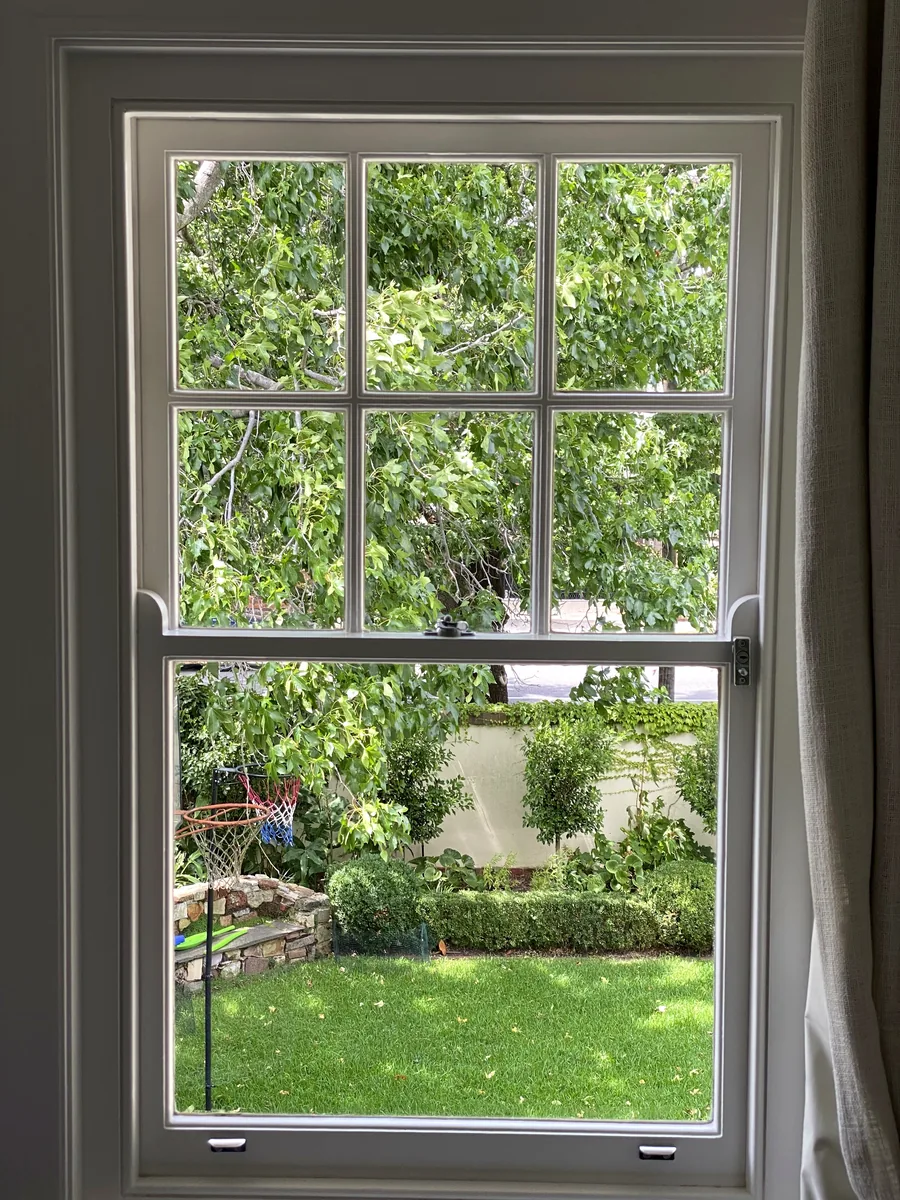 Clean sash window with a clear view over a garden