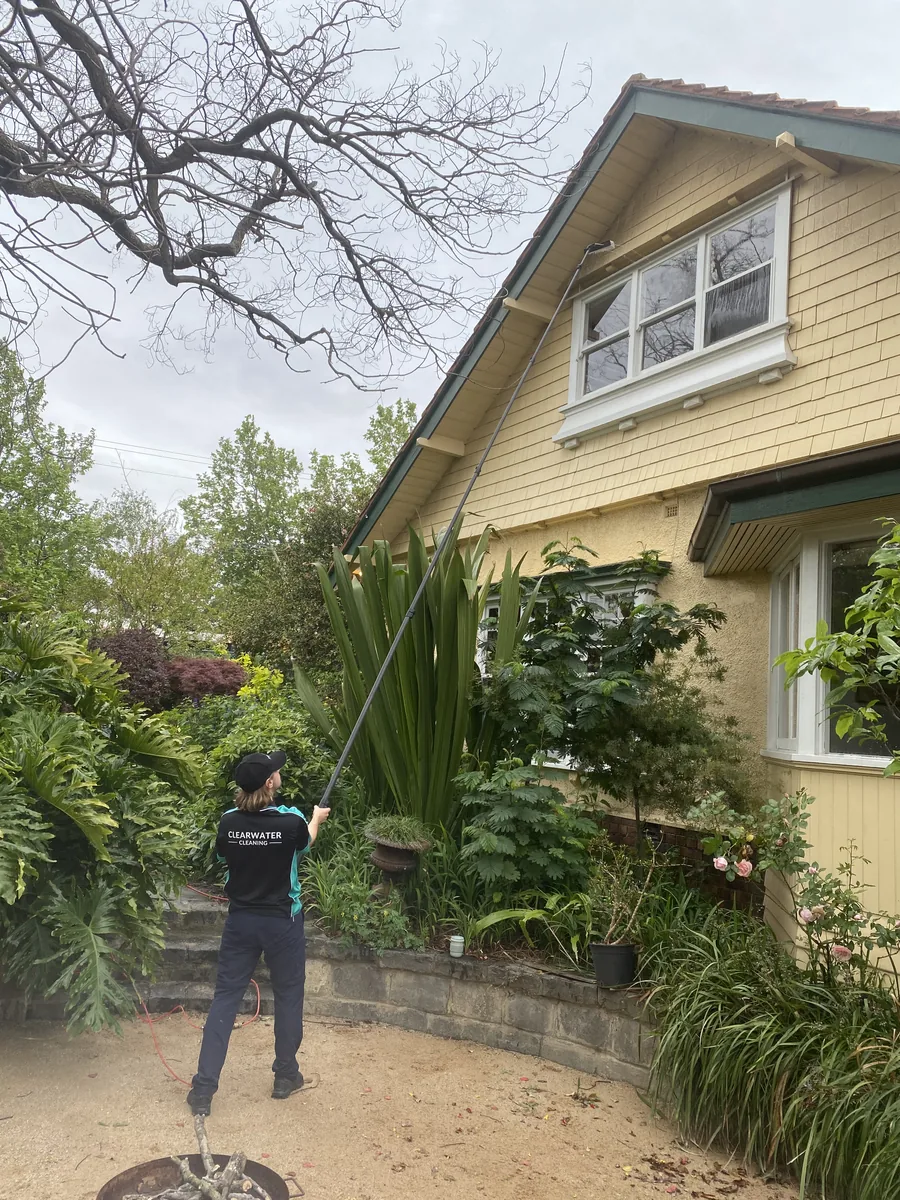 Window cleaner working on a period weatherboard home in Melbourne
