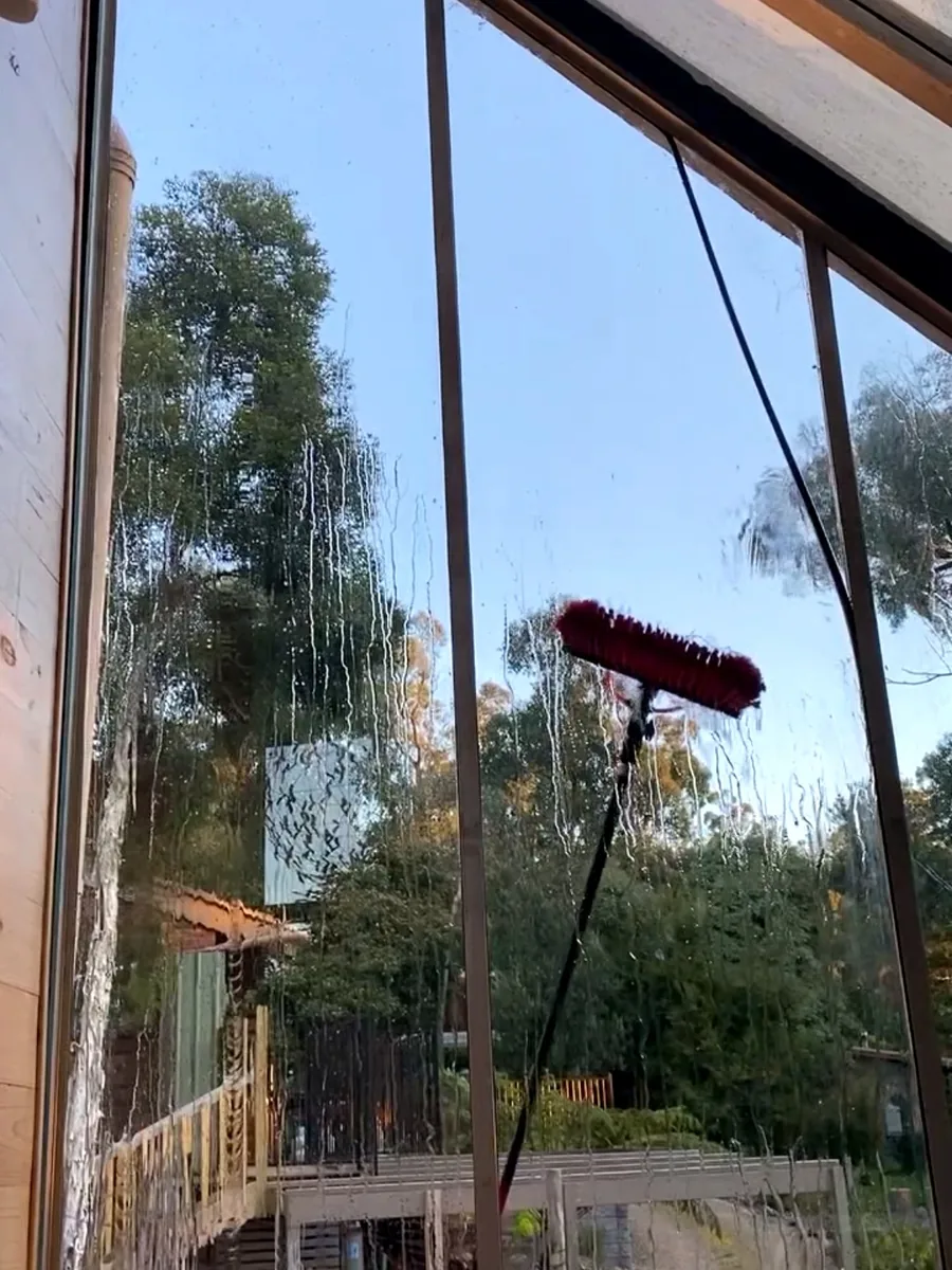 Brush cleaning exterior glass with filtered pure water