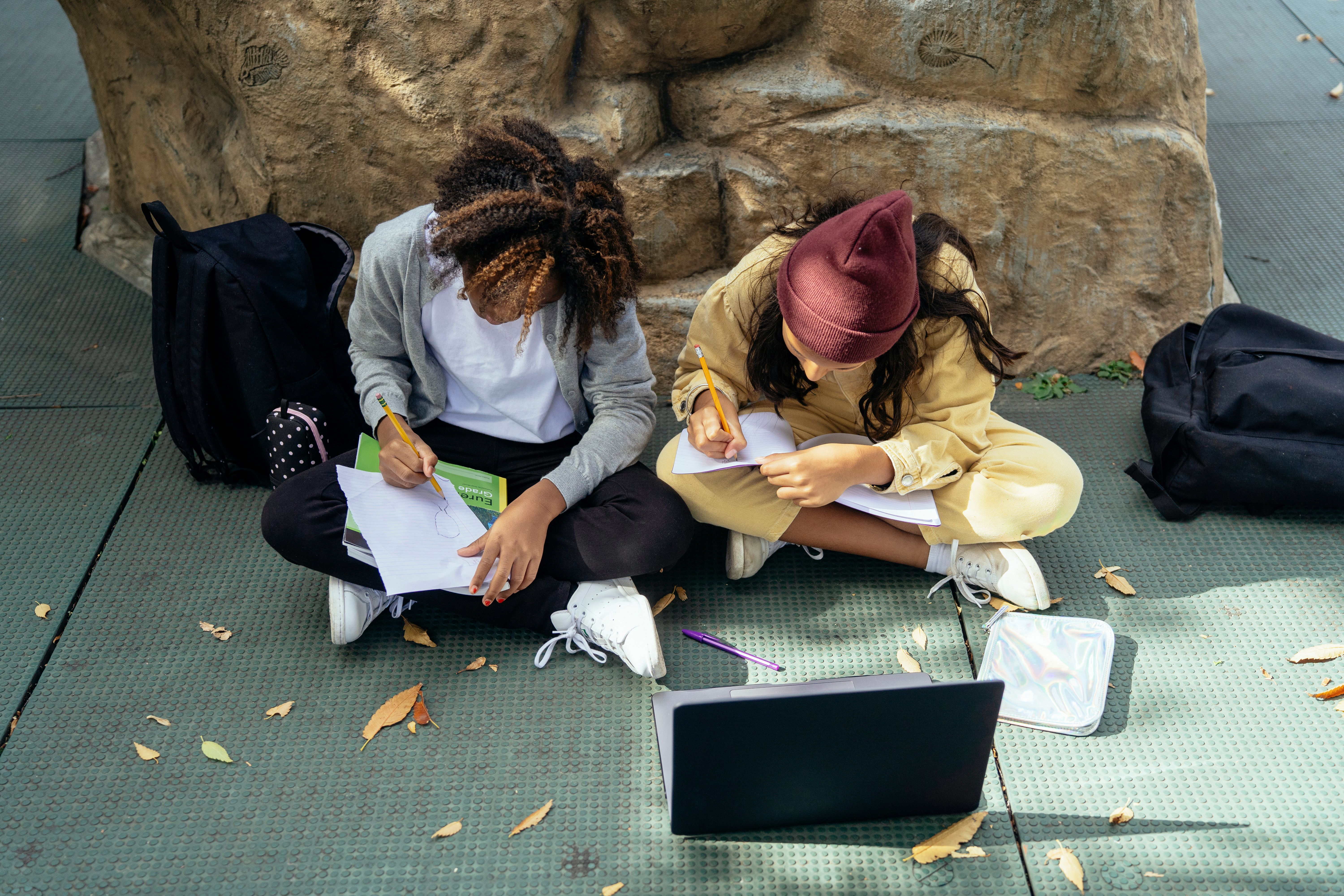 Two students working together outdoors on a hands-on project