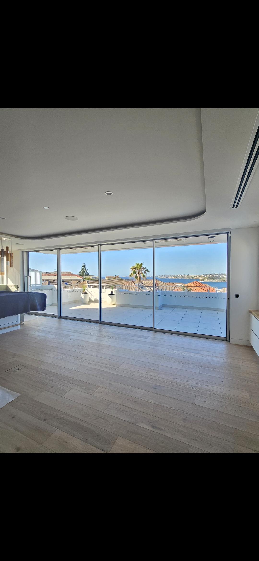 Alutec Windows premium residential home with expansive aluminium sliding doors opening to a sun-drenched terrace