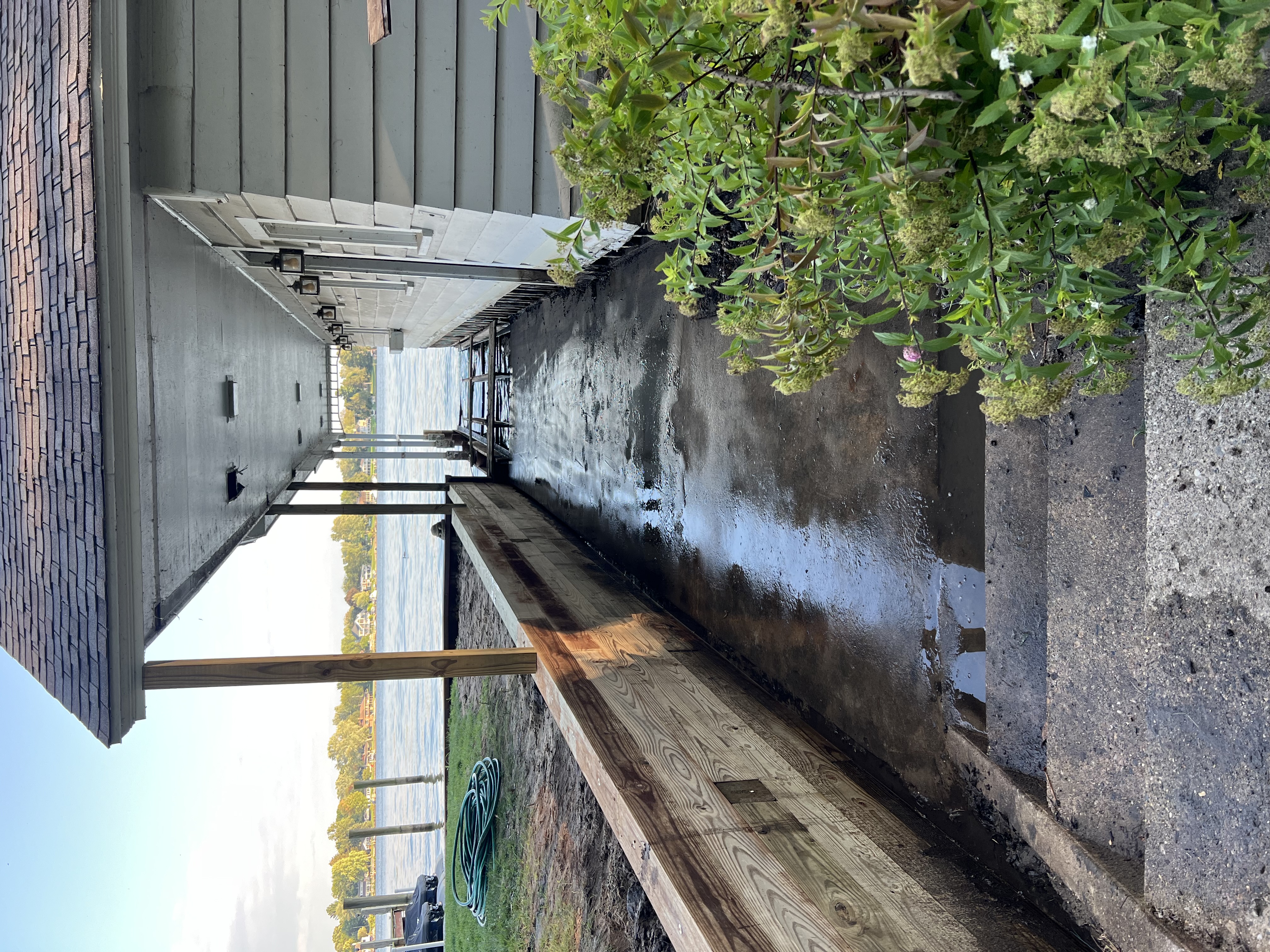 Before photo of waterfront porch and walkway prior to deck construction
