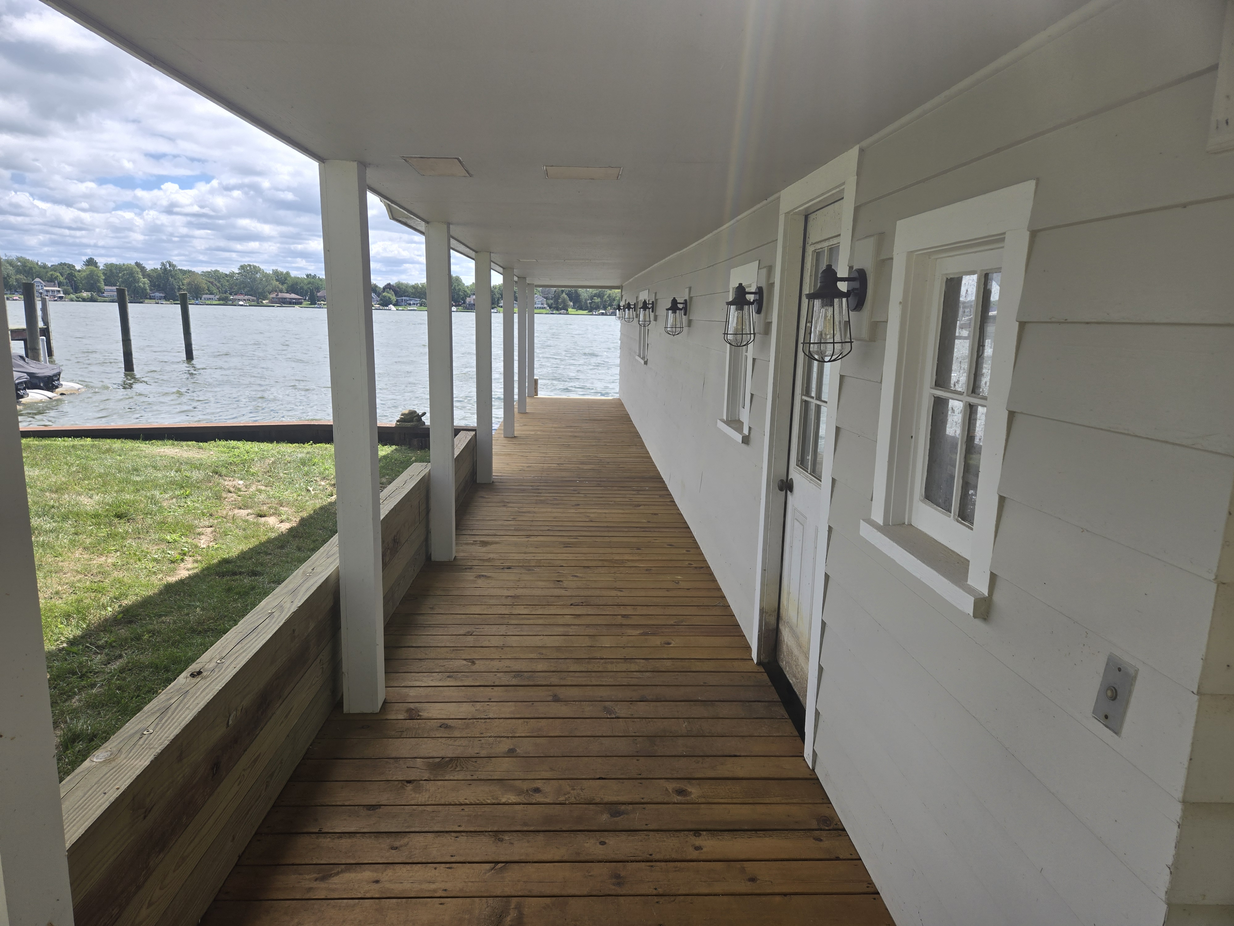 After photo showing finished wood deck boardwalk and porch construction along the lake