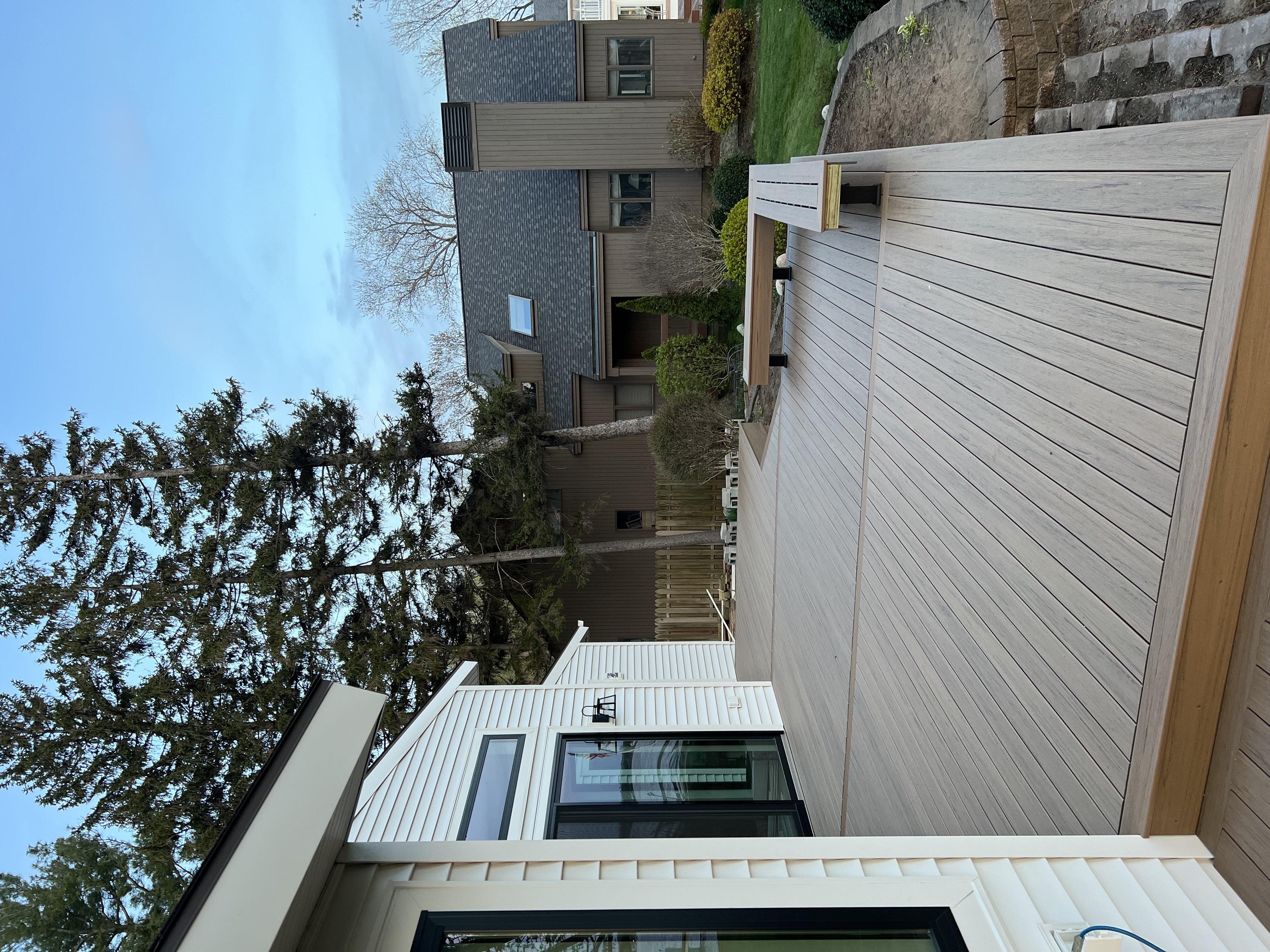Finished residential composite deck with built-in bench overlooking the yard