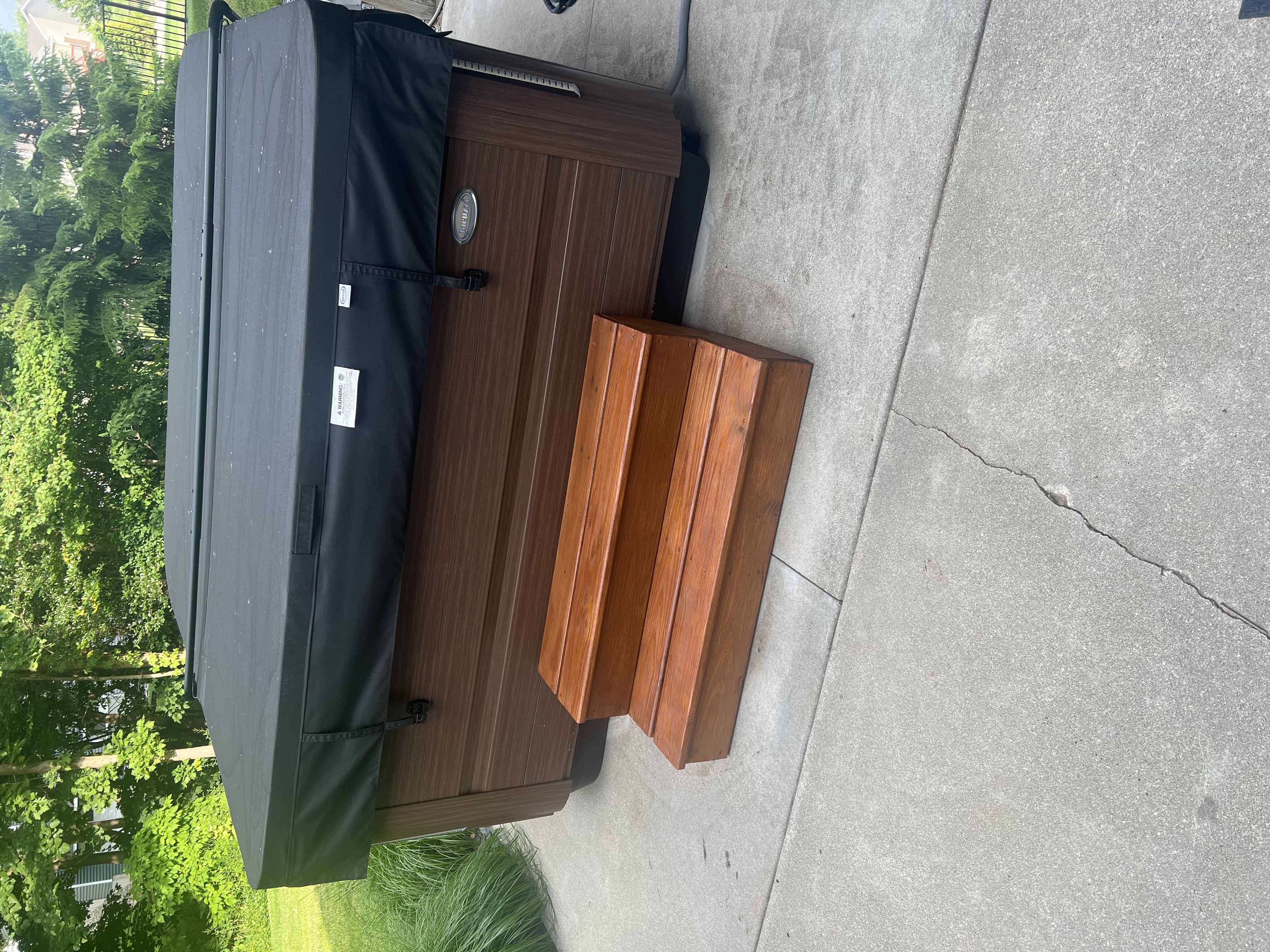 Outdoor living space with hot tub surround and custom wooden steps
