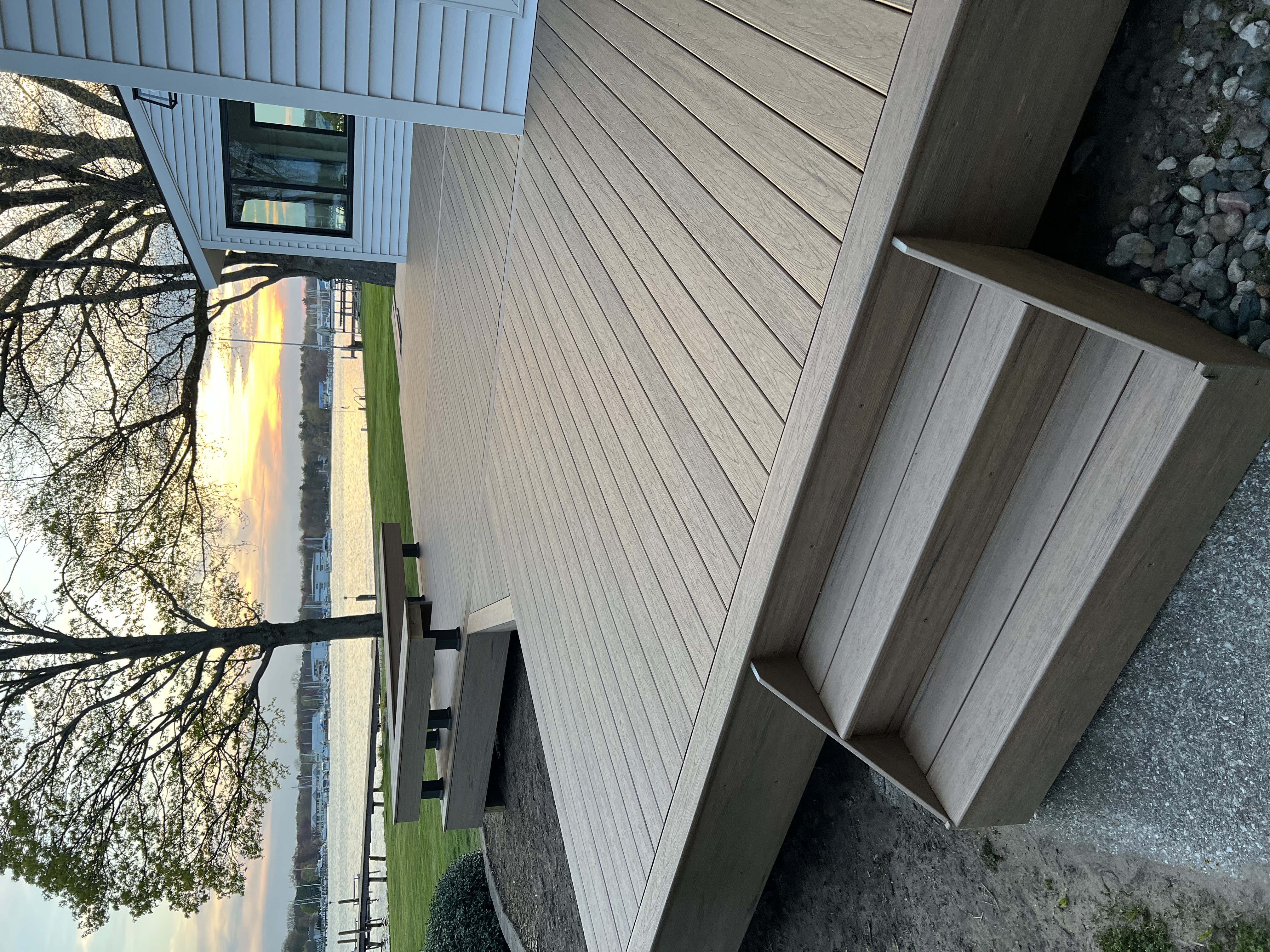 After photo showing the completed composite deck with built-in bench and steps