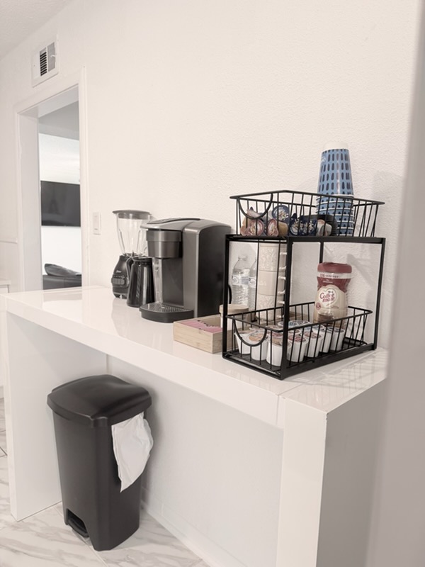 RCS Legacy Living common area coffee station with white countertop, beverage supplies, and welcoming residential atmosphere