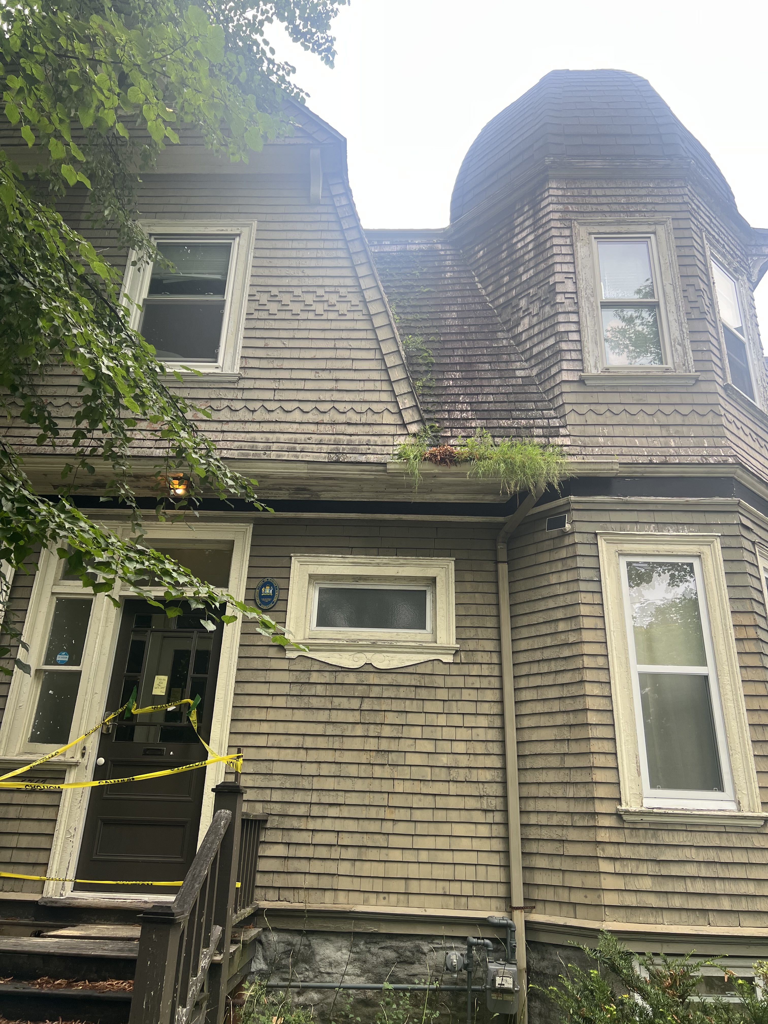 Overgrown Gutters and Cedar Shingle Exterior