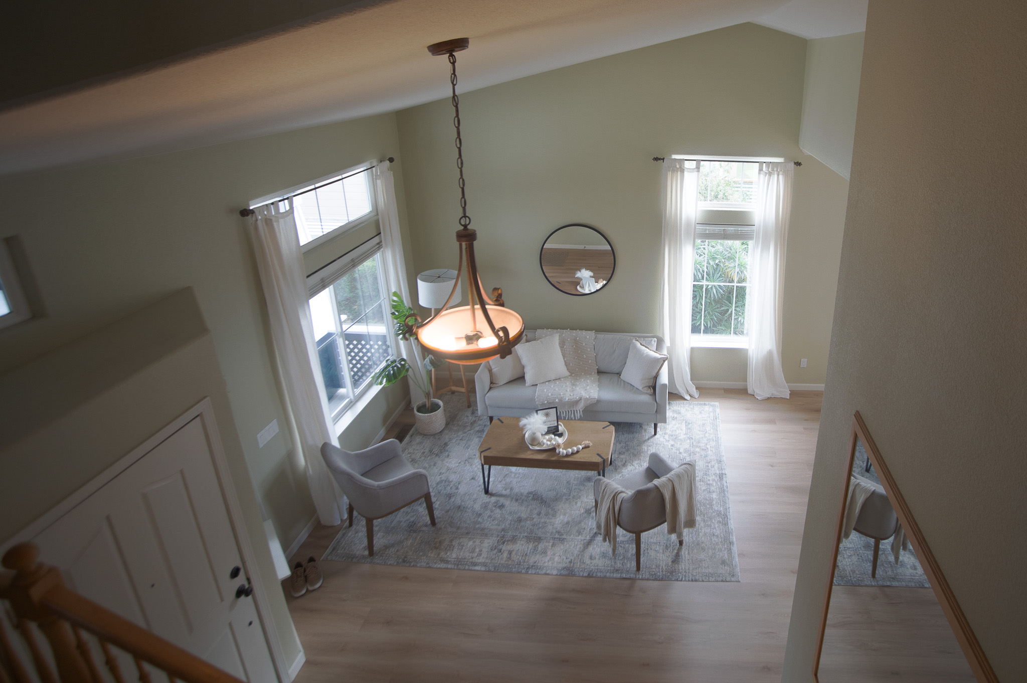 Spacious living room with natural light and chandelier