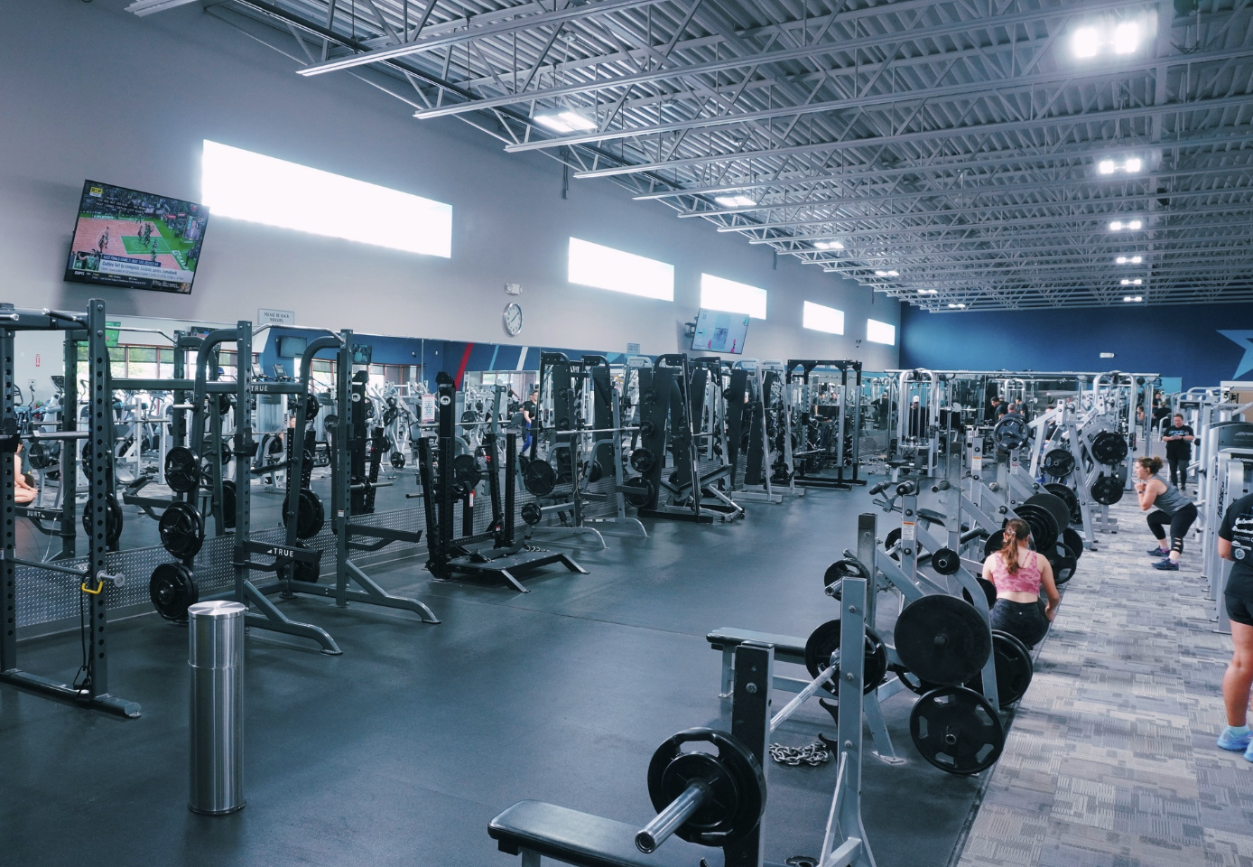 Wide panoramic view of the massive 20,000 sq ft Fitness Premier Highlands Ranch facility showing multiple training zones