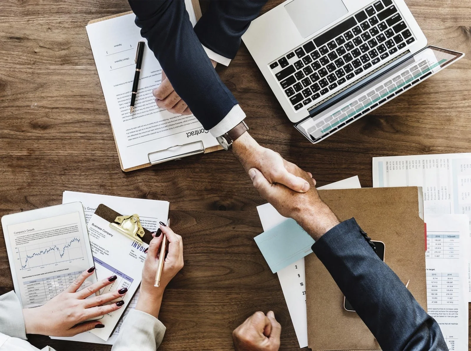 Business professionals meeting around a desk